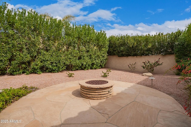 view of patio / terrace with an outdoor fire pit and fence