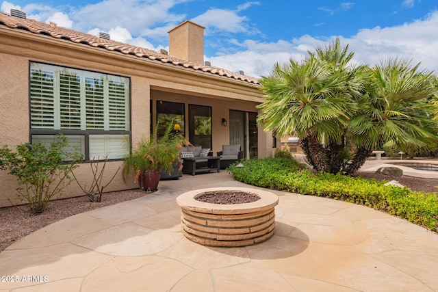 view of patio featuring an outdoor living space with a fire pit