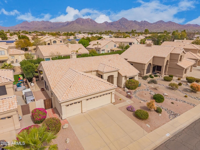 birds eye view of property with a residential view and a mountain view