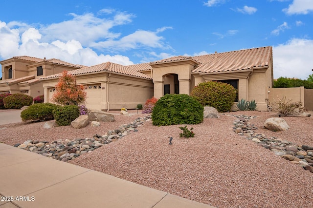 view of front of house with a garage, a tiled roof, and stucco siding