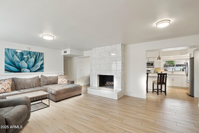 5119 E Shaw Butte Dr, Scottsdale, AZ 85254 - living room featuring light wood finished floors and a fireplace