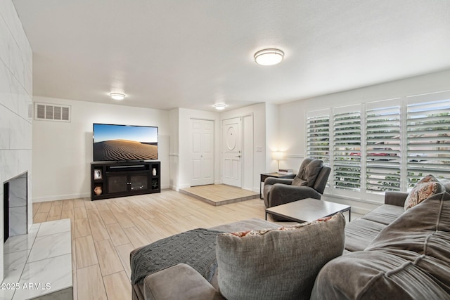 5119 E Shaw Butte Dr, Scottsdale, AZ 85254 - living area featuring wood finished floors, baseboards, and a tiled fireplace