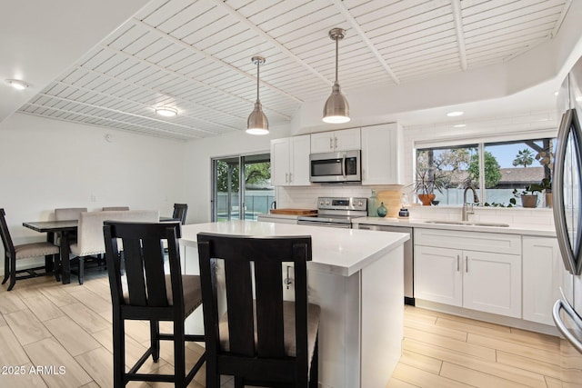 5119 E Shaw Butte Dr, Scottsdale, AZ 85254 - kitchen featuring stainless steel appliances, a sink, a kitchen island, light countertops, and backsplash