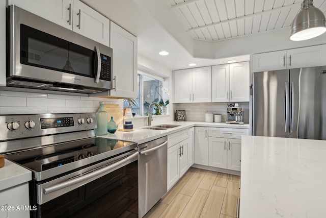5119 E Shaw Butte Dr, Scottsdale, AZ 85254 - kitchen with appliances with stainless steel finishes, a sink, white cabinets, backsplash, and recessed lighting