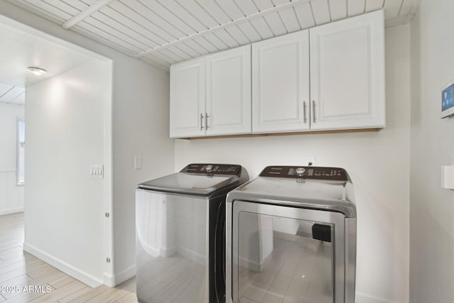 5119 E Shaw Butte Dr, Scottsdale, AZ 85254 - washroom featuring cabinet space, washing machine and clothes dryer, baseboards, and light wood-type flooring