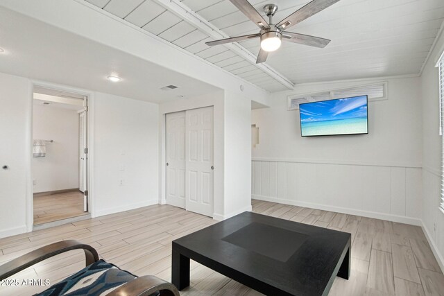 5119 E Shaw Butte Dr, Scottsdale, AZ 85254 - living area featuring ceiling fan, light wood finished floors, beamed ceiling, and a wainscoted wall