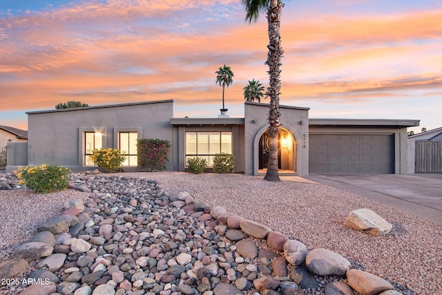 5119 E Shaw Butte Dr, Scottsdale, AZ 85254 - view of front of property with stucco siding, a garage, and driveway