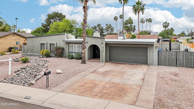 5119 E Shaw Butte Dr, Scottsdale, AZ 85254 - view of front of house featuring a chimney, an attached garage, stucco siding, concrete driveway, and fence