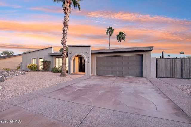 5119 E Shaw Butte Dr, Scottsdale, AZ 85254 - mid-century modern home featuring a garage, stucco siding, driveway, and fence
