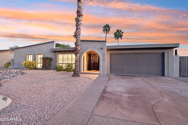 5119 E Shaw Butte Dr, Scottsdale, AZ 85254 - view of front facade featuring stucco siding, driveway, and an attached garage