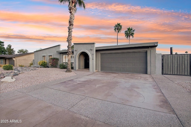 5119 E Shaw Butte Dr, Scottsdale, AZ 85254 - mid-century modern home with an attached garage, stucco siding, and driveway
