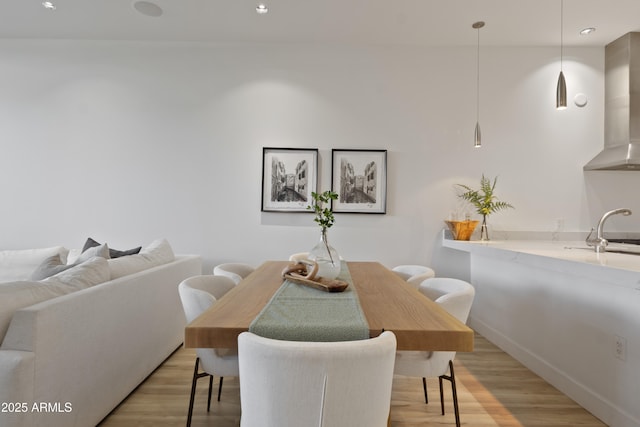 dining area featuring sink and light hardwood / wood-style floors