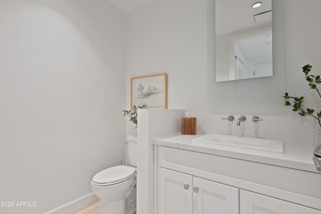 bathroom featuring vanity and toilet