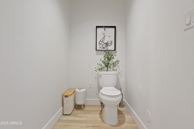 bathroom featuring hardwood / wood-style floors and toilet