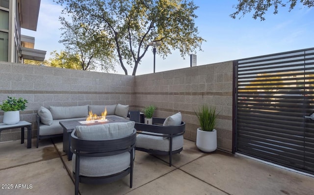 view of patio featuring an outdoor living space with a fire pit