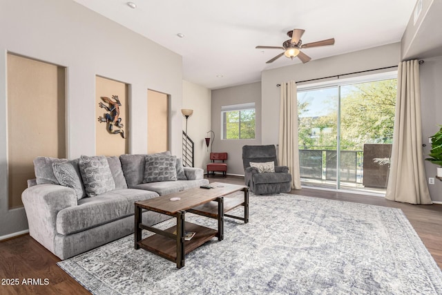 living room with dark hardwood / wood-style floors and ceiling fan