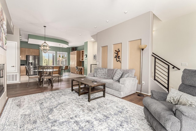 living room featuring dark hardwood / wood-style floors and a chandelier