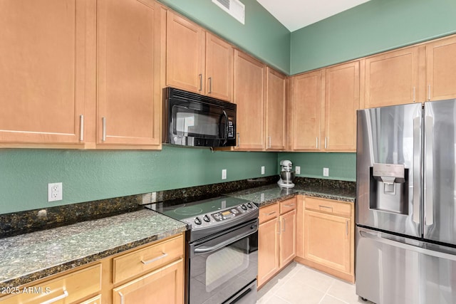 kitchen with black appliances, dark stone counters, and light tile patterned flooring