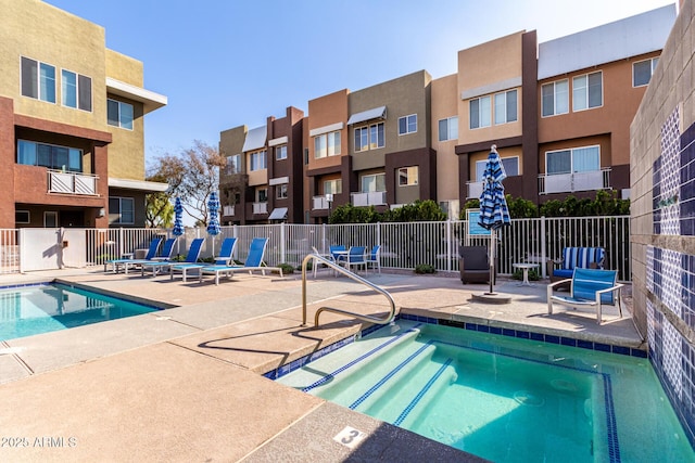 view of swimming pool featuring a patio and a community hot tub