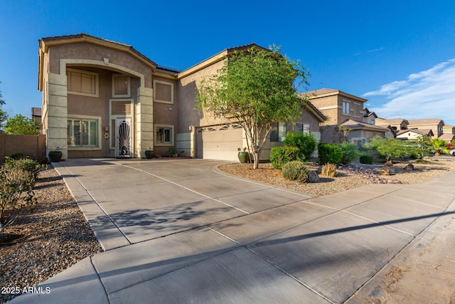 view of front of property featuring a residential view, driveway, and stucco siding