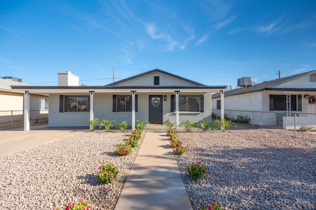 1135 E 4th St, Casa Grande, AZ 85122 - view of front facade featuring a porch, a chimney, stucco siding, and central air condition unit