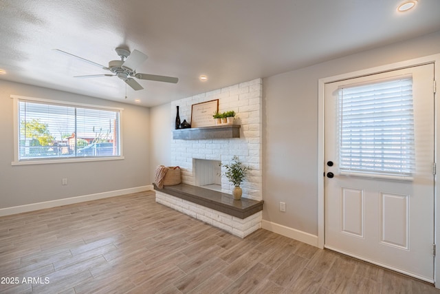 1135 E 4th St, Casa Grande, AZ 85122 - living room with a brick fireplace, baseboards, light wood-type flooring, a ceiling fan, and recessed lighting