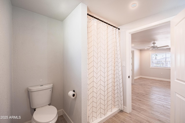 1135 E 4th St, Casa Grande, AZ 85122 - bathroom featuring toilet, baseboards, wood finished floors, and ceiling fan