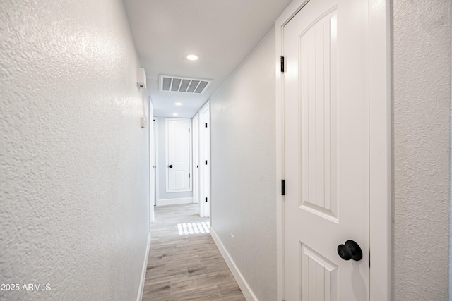 1135 E 4th St, Casa Grande, AZ 85122 - hall featuring baseboards, light wood-type flooring, a textured wall, and recessed lighting