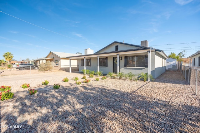 1135 E 4th St, Casa Grande, AZ 85122 - view of front of home featuring a chimney, a porch, stucco siding, and cooling unit