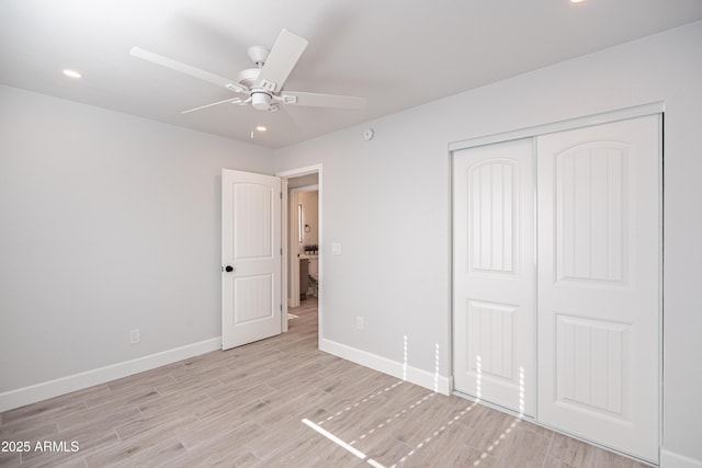 1135 E 4th St, Casa Grande, AZ 85122 - unfurnished bedroom featuring baseboards, light wood-type flooring, a closet, recessed lighting, and ceiling fan