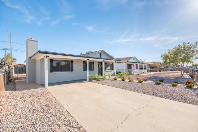 1135 E 4th St, Casa Grande, AZ 85122 - single story home featuring stucco siding, a chimney, covered porch, and concrete driveway