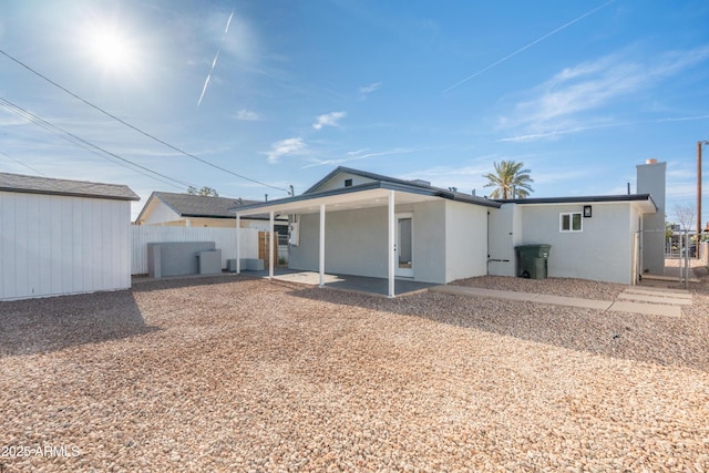 1135 E 4th St, Casa Grande, AZ 85122 - rear view of house with a patio, stucco siding, a gate, and a chimney