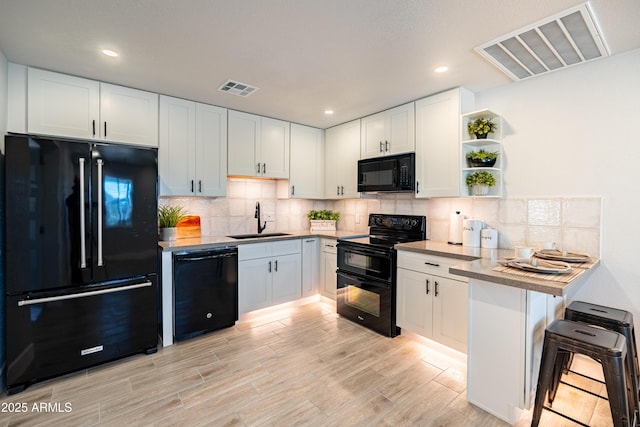1135 E 4th St, Casa Grande, AZ 85122 - kitchen featuring black appliances, a sink, open shelves, white cabinets, and tasteful backsplash