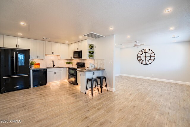 1135 E 4th St, Casa Grande, AZ 85122 - kitchen with black appliances, open shelves, a sink, decorative backsplash, and baseboards
