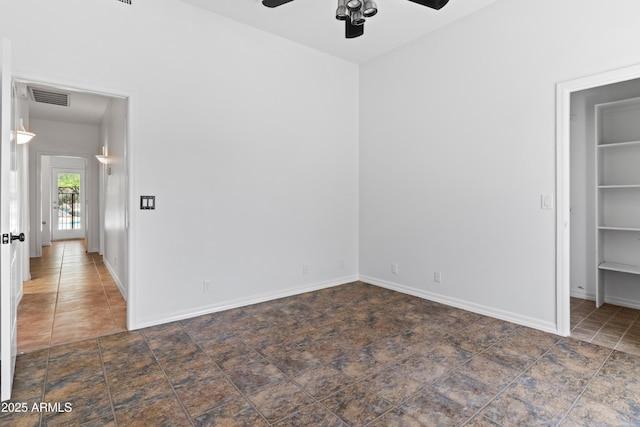 33519 N 62nd St, Cave Creek, AZ 85331 - unfurnished bedroom with dark tile patterned flooring, a spacious closet, ceiling fan, baseboards, and visible vents