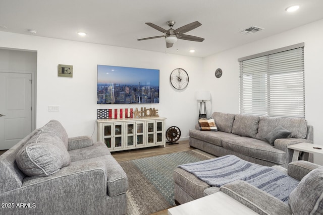 living room featuring a ceiling fan, recessed lighting, visible vents, and wood finished floors