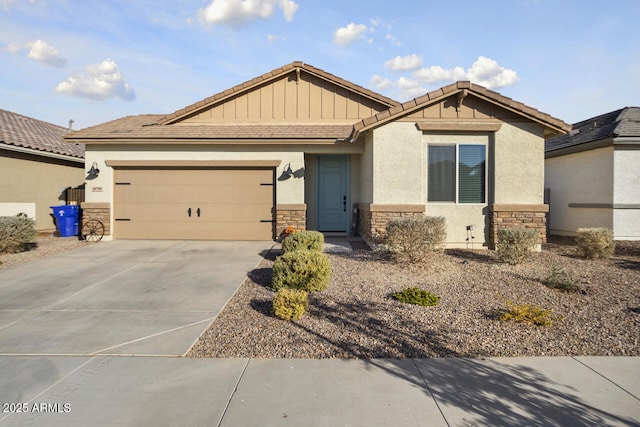 craftsman-style home with driveway, a garage, stone siding, a tiled roof, and stucco siding