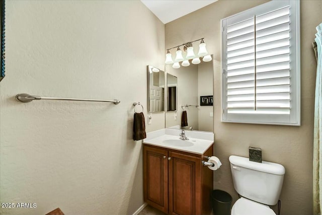 bathroom featuring toilet and vanity