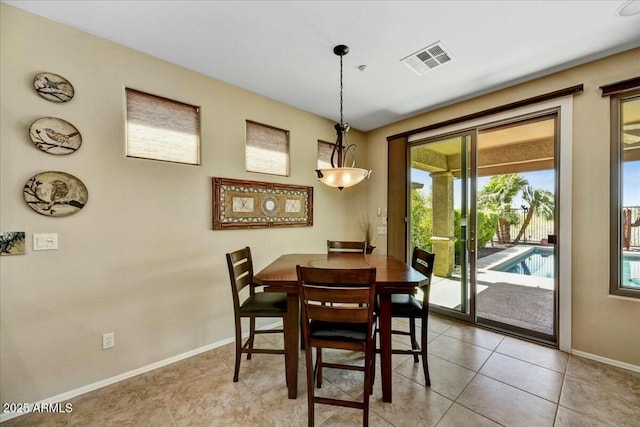 dining area with light tile patterned floors, baseboards, and visible vents