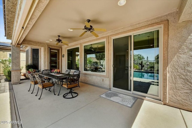view of patio with outdoor dining space and a ceiling fan