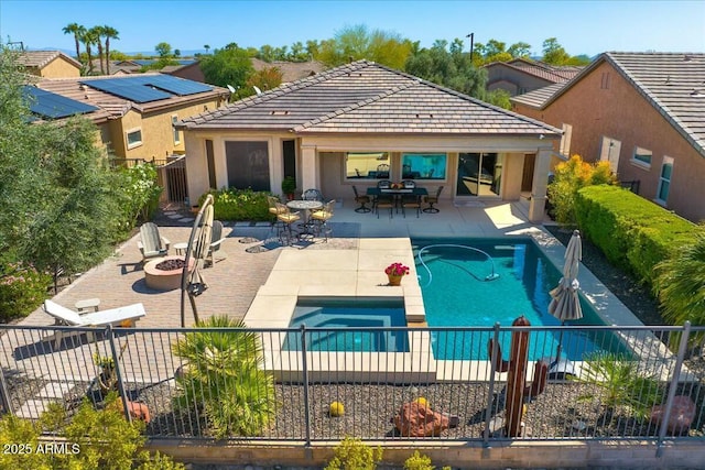 exterior space with a fenced backyard, a fenced in pool, a fire pit, and a patio
