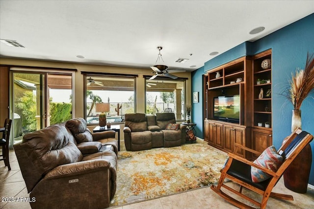 tiled living room with visible vents and ceiling fan
