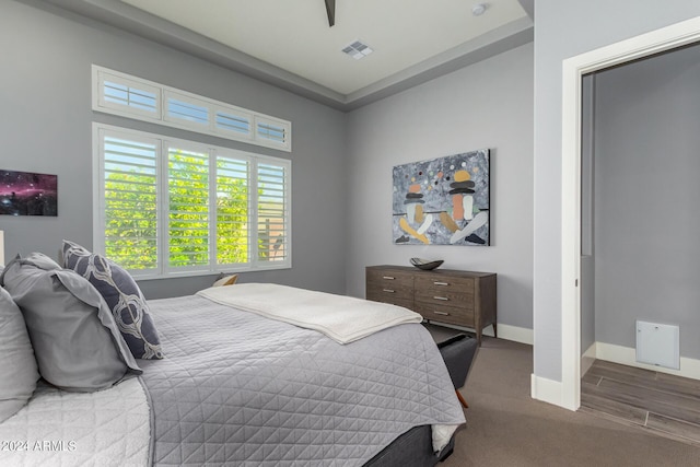 carpeted bedroom with visible vents and baseboards