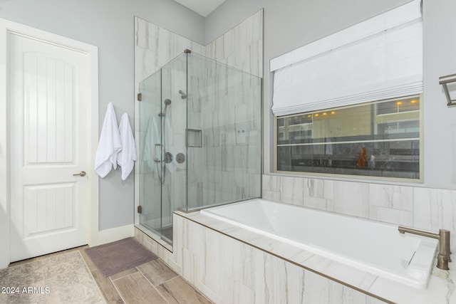 bathroom with a garden tub and a shower stall