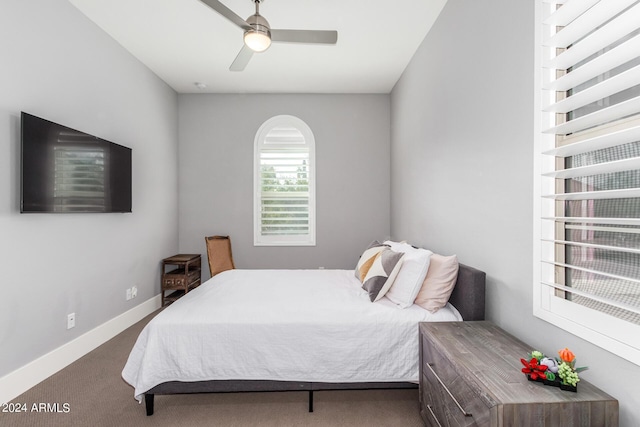 carpeted bedroom featuring ceiling fan and baseboards