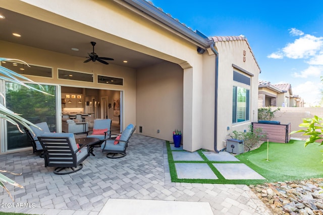 view of patio / terrace with fence and ceiling fan