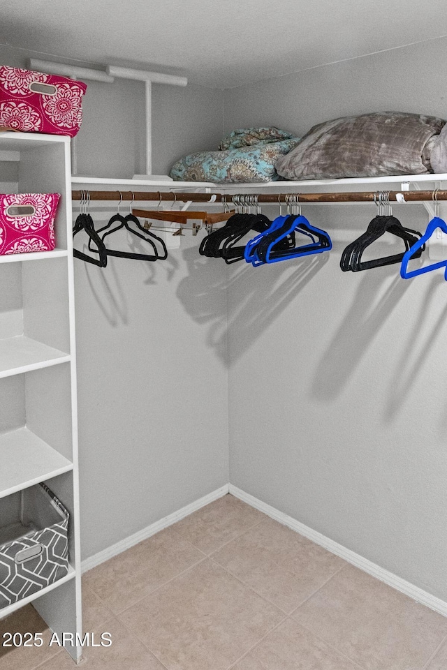walk in closet with tile patterned flooring