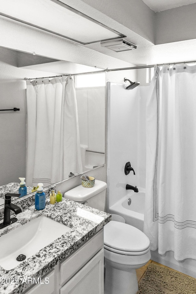 full bathroom with shower / bath combo with shower curtain, toilet, and vanity