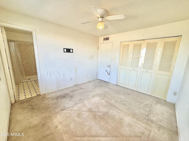 unfurnished bedroom with visible vents, a textured ceiling, a closet, and a ceiling fan