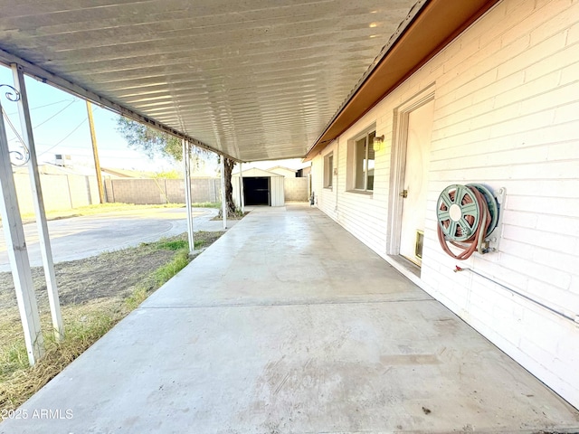 view of patio / terrace featuring an outdoor structure and fence